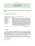 Modeling and analysis of vibration of a gold nano-beam under two-temperature theory